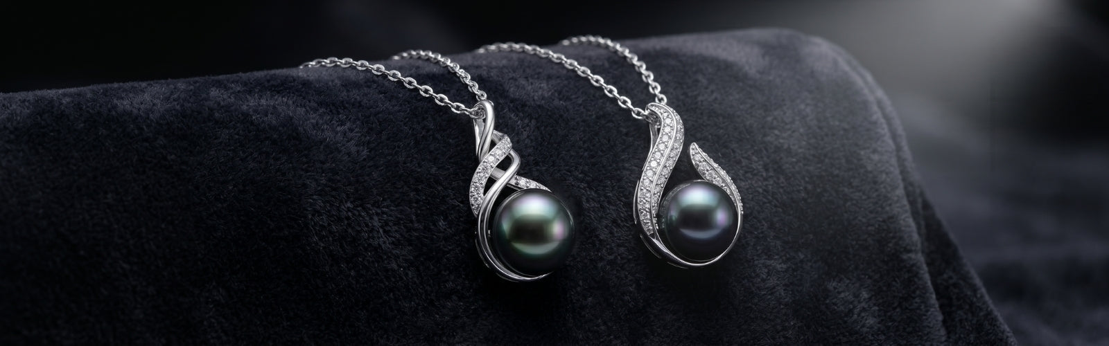 Luxury Tahitian black pearl necklace from TRYNDI JEWELRY displayed on dark velvet with soft spotlight