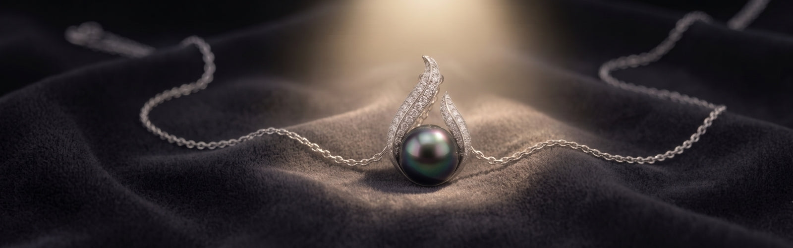 Luxury Tahitian black pearl necklace from TRYNDI JEWELRY on dark velvet background, soft spotlight, mysterious elegant mood
