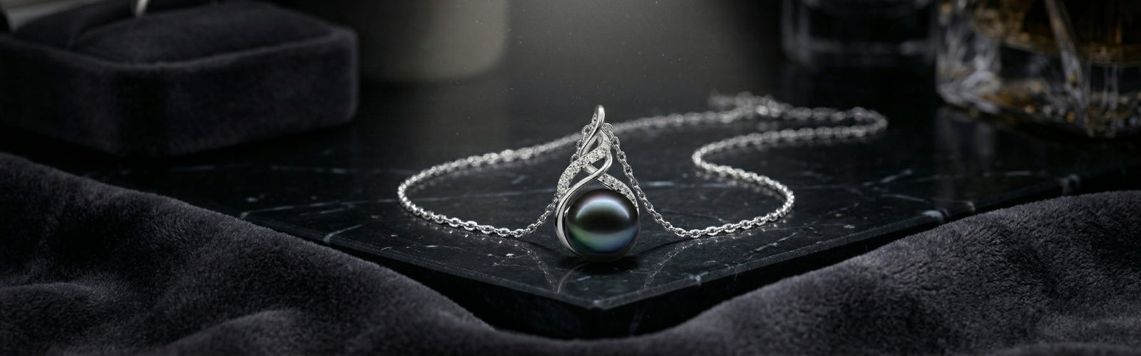 Luxury Tahitian black pearl necklace on dark velvet background, soft spotlight, cinematic jewelry